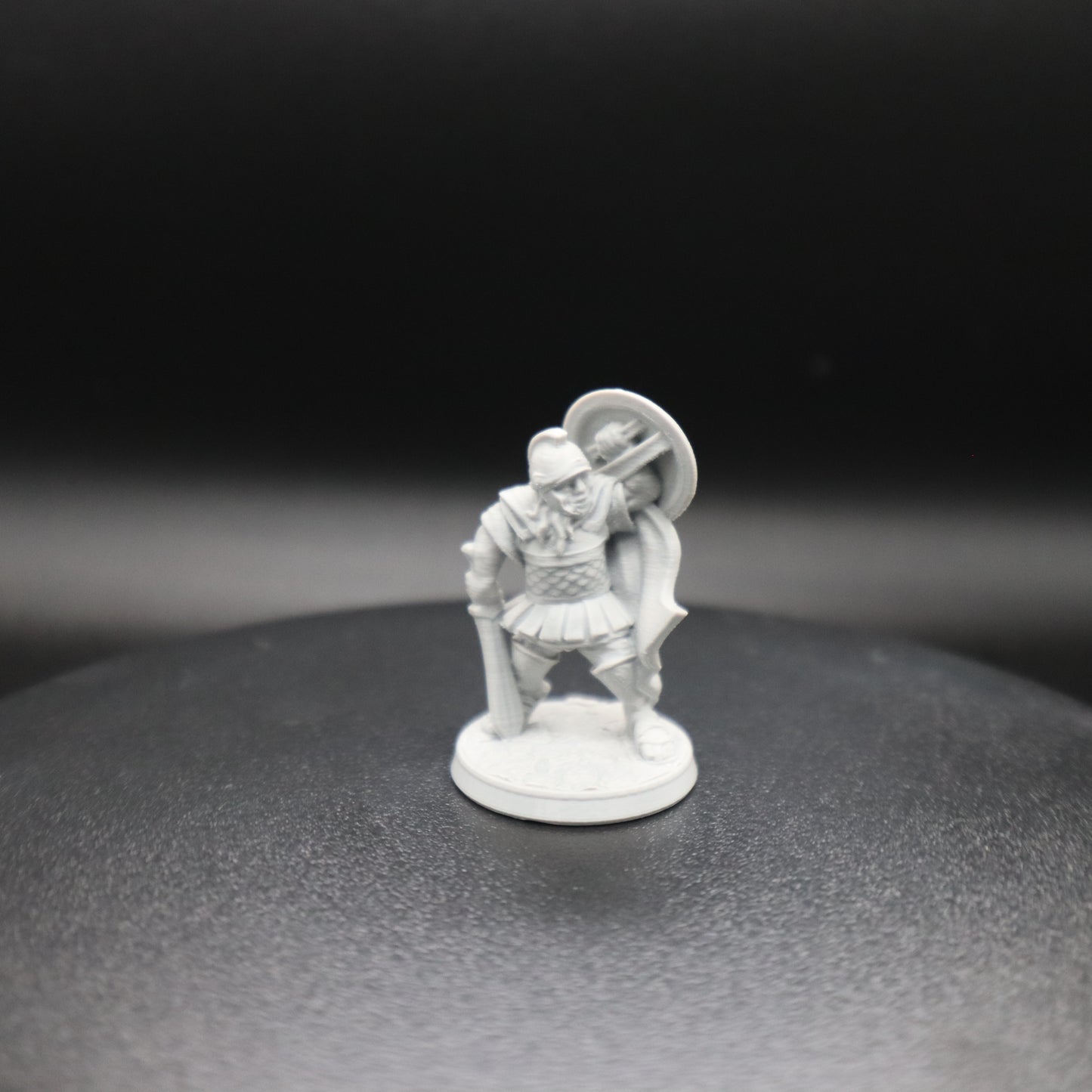Greek Hoplite Holding a Sword and Shielding a Strike from Above